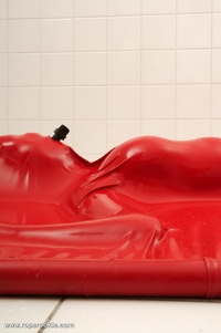 Blond babe is bound in air tight latex